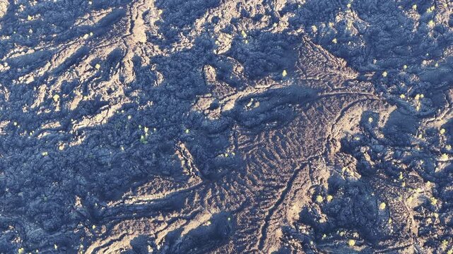 A bird's eye view of an ancient lava field shows an extremely rugged and inhospitable landscape near Bend, Oregon. This vast area is part of the volcanic Cascade Mountain Range.