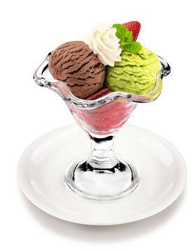 Assorted ice cream scoops of chocolate, pistachio, and strawberry served in a glass sundae cup with whipped cream and mint on a white background