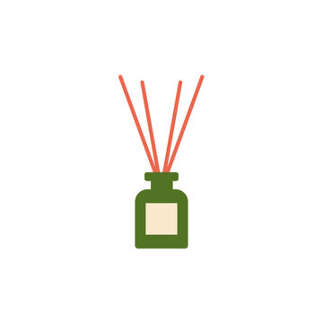 Green fragrance diffuser bottle decorated with natural reed sticks.