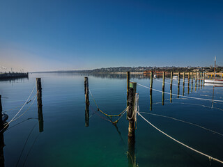 Fototapeta premium Pilings And Ropes Lead To Deserted Anchorage