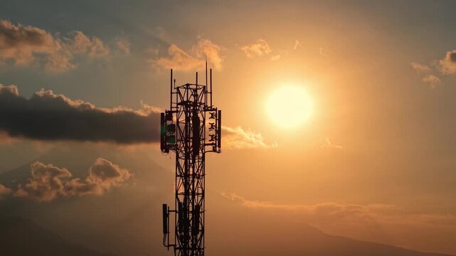 Signal transmission tower against golden sunset backdrop, silhouette shot. Telecommunication, network, and technology infrastructure concept footage.