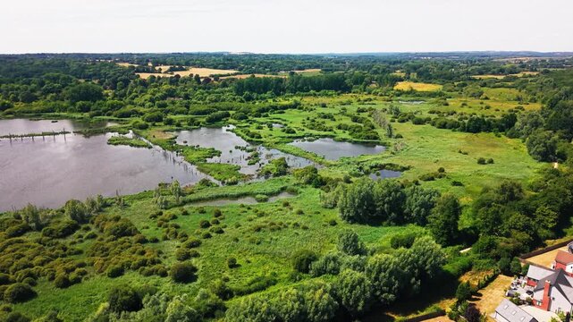 Drone shot over Fishlake Meadows' patchwork of wetland pools, reed scrub and open meadow near Romsey.