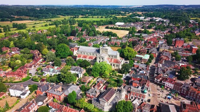 Drone tracks left to right across Romsey Abbey and the surrounding town, with fields beyond.