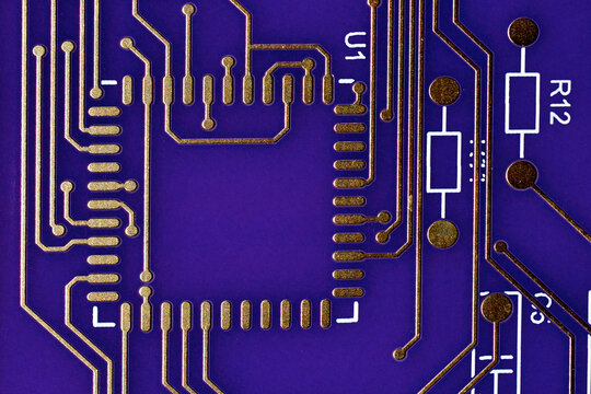 Closeup of Component placement with conductor traces on purple circuit board 