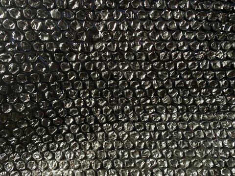 Black bubble wrap texture background for packaging and protection concept. shipping protection.