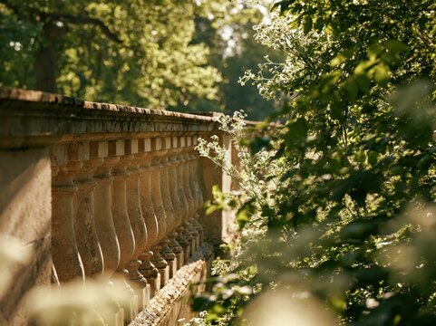 Stone balustrade in a sunlit garden with green foliage