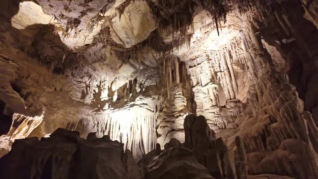 Dramatic view of illuminated limestone cave shields and intricate dripstone formations inside Lehman Caves Nevada