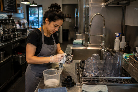 Cafe Worker Cleaning Blender Equipment During Closing-Time Sanitization
