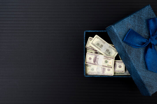 Cash Bundles Inside Blue Gift Box Symbolizing Money Gift, Bonus and Financial Reward