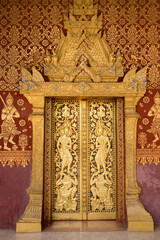 Elaborate wood carvings at Wat Saen's entrance door, Luang Prabang, Laos © Julia