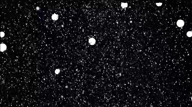 Bright white snowflakes falling in the soft night sky against a black background, showcasing beautiful winter weather. Ideal for seasonal designs and christmas
