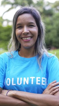 Happy Asian woman volunteer smiling outdoors - Community charity support and social project concept - Vertical video