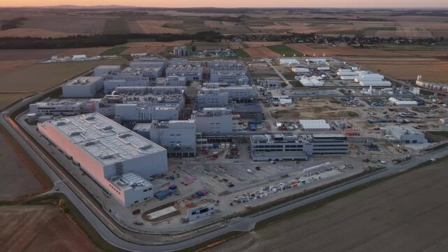 Aerial drone view of Umicore battery materials production plant in Radzikowice near Nysa, Poland, surrounded by agricultural fields. Factory producing cathode materials for lithium ion batteries