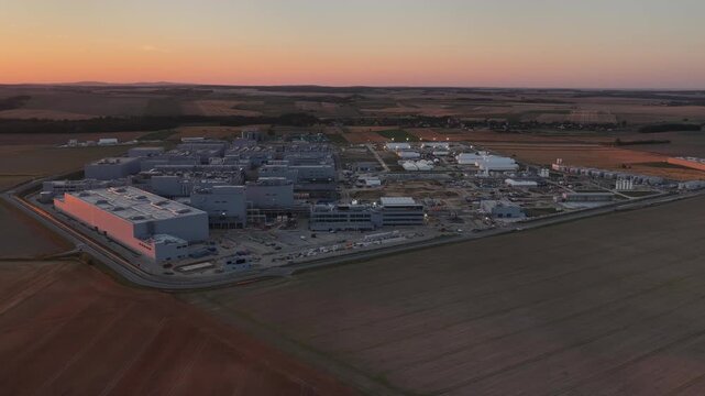 Aerial drone view of Umicore battery materials production plant in Radzikowice near Nysa, Poland, surrounded by agricultural fields. Factory producing cathode materials for lithium ion batteries