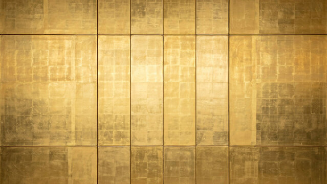 Shiny golden wall panels featuring rectangular tile patterns arranged in a symmetrical modern architectural interior design