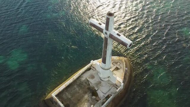 Aerial view of sunken cemetery and cross at sunrise in camiguin, philippines