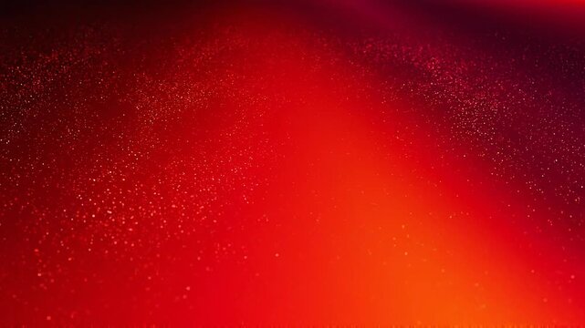 Abstract red and orange gradient background with sparkling particles and glowing light effects
