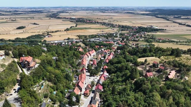 Aerial drone view of Srebrna Gora village in Lower Silesia, Poland, with historic Srebrna Gora Fortress, surrounding mountains and green landscape on a sunny summer day
