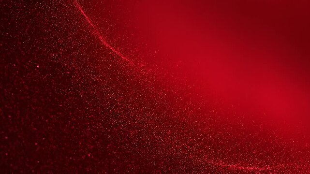 Close up of red sparkling glitter texture with bright glowing highlights for festive holiday background