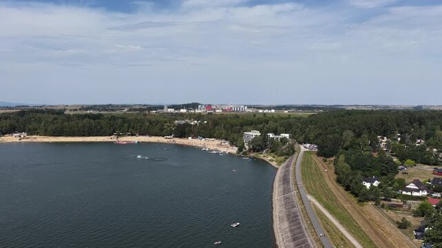 Aerial panorama of Lake Nysa in Lower Silesia, Poland during summer holiday season, with blue water, green shoreline, surrounding hills and scenic landscape on a sunny day