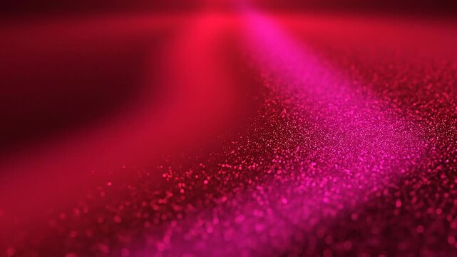 Close up of sparkling red and pink glitter particles creating a smooth shimmering texture background