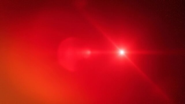Bright red star shining in deep space with glowing nebula and cosmic dust background