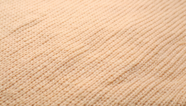 Cozy beige knitted sweater texture background