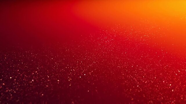 Bright red and orange glowing particles background with sparkling dust and warm light effect