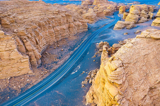 Aerial view of winding asphalt highway through yardang landform in Dahaidao, Hami, Xinjiang, China.