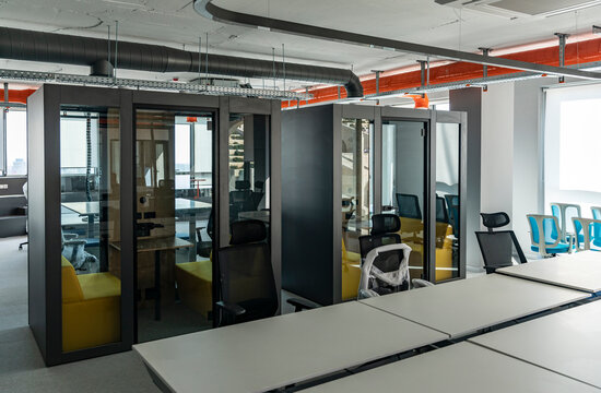 Row of Soundproof Acoustic Meeting Pods with Glass Doors in a Modern Open-Plan Office Under Fitout