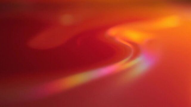 Abstract vibrant red and orange background with smooth flowing light waves and colorful gradient effects