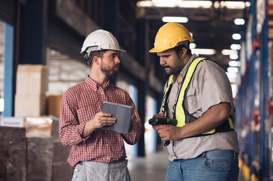 Warehouse worker working and checking the stock in the warehouse. .Factory manager using digital tablet check barcode in industry factory logistic.	
