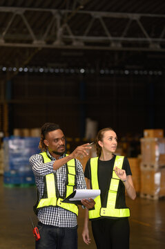 Warehouse worker working and checking the stock in the warehouse. .Factory manager using digital tablet check barcode in industry factory logistic.	