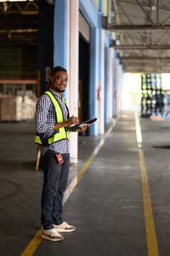Warehouse worker working and checking the stock in the warehouse. .Factory manager using digital tablet check barcode in industry factory logistic.	
