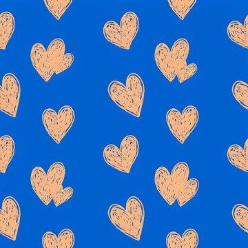 Seamless pattern of hand drawn peach colored hearts on a vibrant blue background