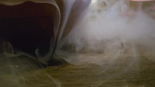 Abstract white smoke swirling through dark water, with soft cloudy trails, flowing wisps, moody lighting, and slow motion texture for backgrounds, transitions, or creative visual effects.