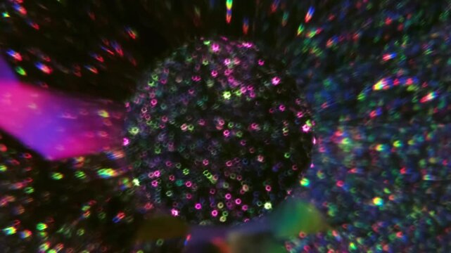 Blur gleam glint. Neon radiant light. Defocused purple blue green color crystal round glitter texture on abstract illuminated luminous dark black background.