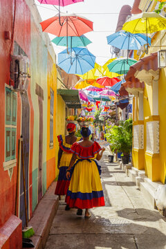 Palenquera women on a colorful umbrella street, Cartagena, Colombia