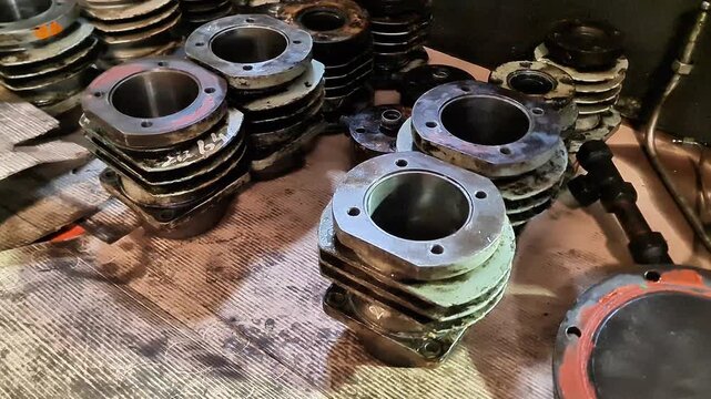 Stack of Vintage 2-Stroke Scooter Engine Cylinder Blocks and Heads for Classic Motorcycle Restoration