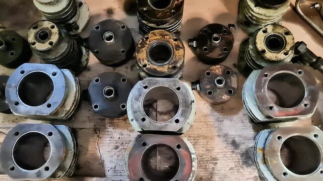 Stack of Vintage 2-Stroke Scooter Engine Cylinder Blocks and Heads for Classic Motorcycle Restoration