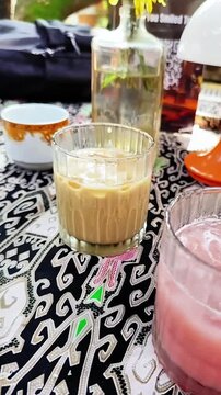 Depok, West Java, Indonesia - October 27 2025: High quality 1080p 60fps footage capturing the atmosphere of serving authentic traditional food and beverages. Perfect for documentaries.