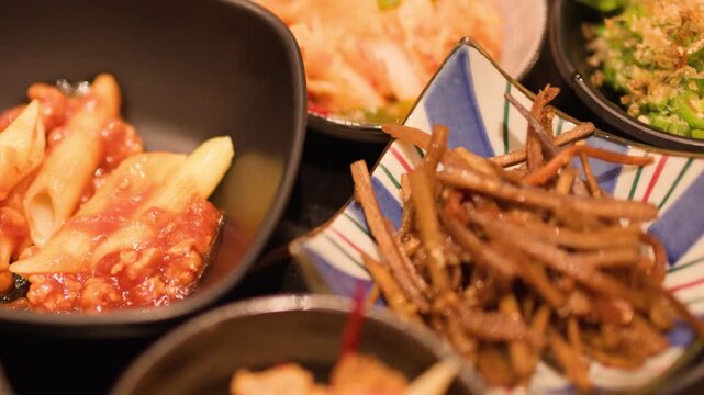 Assorted Japanese Izakaya Side Dishes and Appetizers in Ceramic Bowls