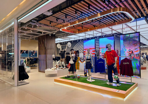 BANGKOK, THAILAND - JULY 16, 2026: Adidas retail store display at Siam Paragon shopping mall featuring mannequins wearing national football team jerseys on artificial grass.