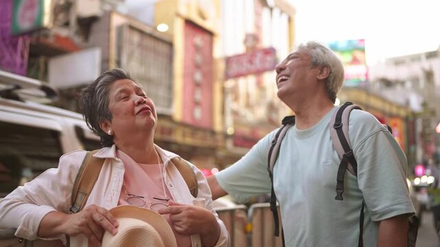 Asian senior couple traveler traveling and exploring the city outdoors.