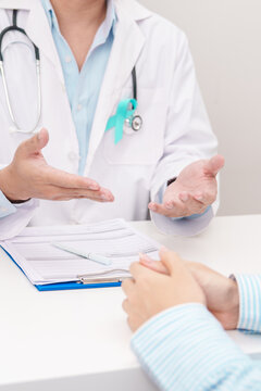 Doctor and patient having a medical consultation for Teal ribbon concept of September Ovarian Cancer Awareness month, PCOS, January Cervical Cancer, April Sexual Assault, June PSTD