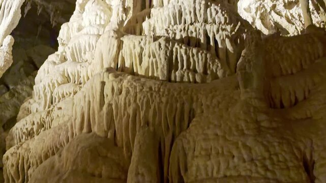Dramatic view of illuminated limestone cave shields and intricate dripstone formations inside Lehman Caves Nevada