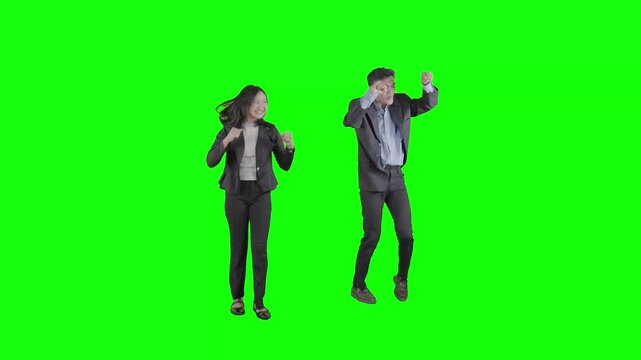 Excited Business Couple Dancing and Celebrating Success Against Green Screen