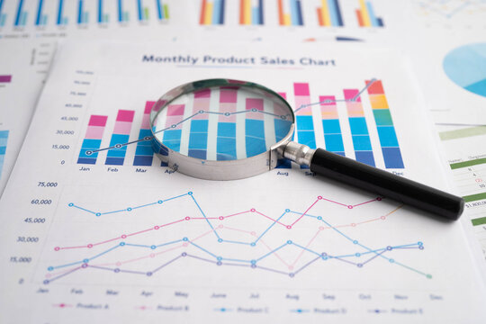 Magnifying glass on charts graphs paper. Financial development, Banking Account, Statistic, Investment Analytic research data economy.