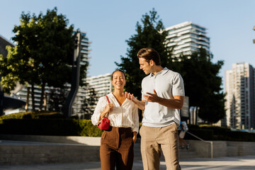 Fototapeta premium Joyful moments shared between friends in a sunny urban park
