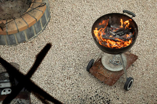 Tbilisi, Georgia - October 10, 2025: Grill lights up with bright flames in outdoor area